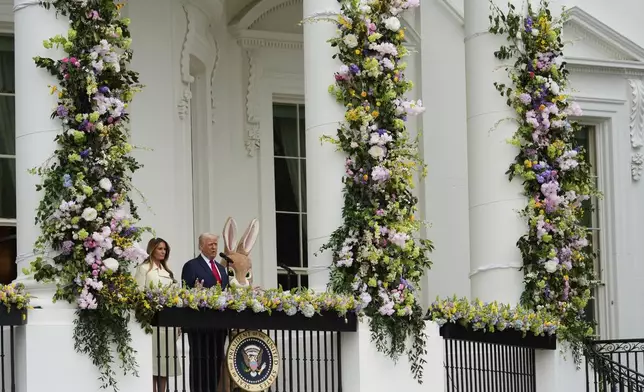 President Donald Trump and first lady Melania Trump arrive on the Blue Room Balcony during the White House Easter Egg Roll on the South Lawn of the White House, Monday, April 21, 2025, in Washington. (AP Photo/Alex Brandon)
