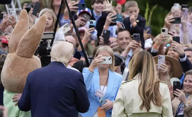 President Donald Trump and first lady Melania Trump attend the White House Easter Egg Roll on the South Lawn of the White House, Monday, April 21, 2025, in Washington. (AP Photo/Alex Brandon)