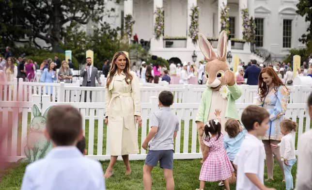 First lady Melania Trump talks with children as they play a game of hopscotch during the White House Easter Egg Roll on the South Lawn of the White House, Monday, April 21, 2025, in Washington. (AP Photo/Mark Schiefelbein)