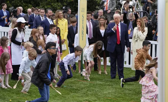 President Donald Trump and first lady Melania Trump watch as children participate durng the White House Easter Egg Roll on the South Lawn of the White House, Monday, April 21, 2025, in Washington. (AP Photo/Alex Brandon)
