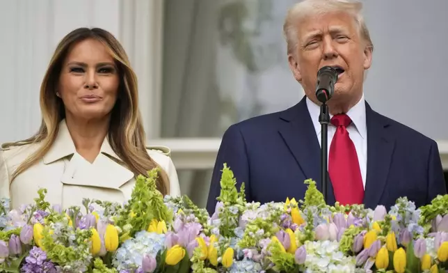 President Donald Trump and first lady Melania Trump stand on the Blue Room Balcony as they participate in the White House Easter Egg Roll being held on the South Lawn of the White House, Monday, April 21, 2025, in Washington. (AP Photo/Mark Schiefelbein)