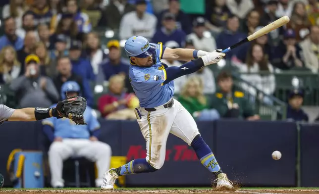 Milwaukee Brewers' Caleb Durbin hits his first major league hit against the Athletics in the third inning of a baseball game Friday, April 18, 2025, in Milwaukee. (AP Photo/Jeffrey Phelps)