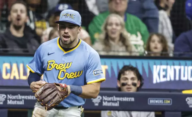 Milwaukee Brewers' Caleb Durbin reacts after catching a foul ball hit by the Athletics' Lawrence Butler during the fifth inning of a baseball game, Friday, April 18, 2025, in Milwaukee. (AP Photo/Jeffrey Phelps)