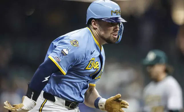 Milwaukee Brewers' Caleb Durbin runs to first base after his first MLB hit, in the third inning of a baseball game against the Athletics, Friday, April 18, 2025, in Milwaukee. (AP Photo/Jeffrey Phelps)