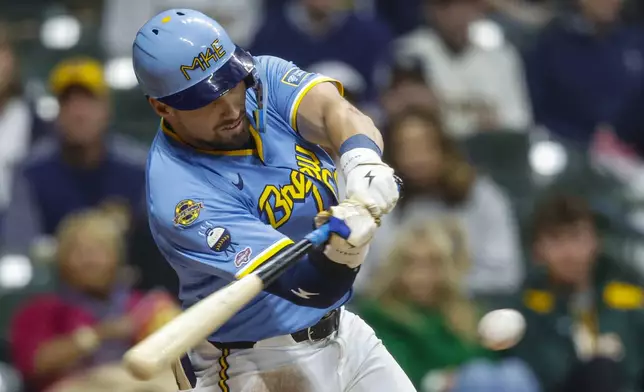 Milwaukee Brewers' Caleb Durbin gets his first MLB hit, in the third inning of a baseball game against the Athletics, Friday, April 18, 2025, in Milwaukee. (AP Photo/Jeffrey Phelps)