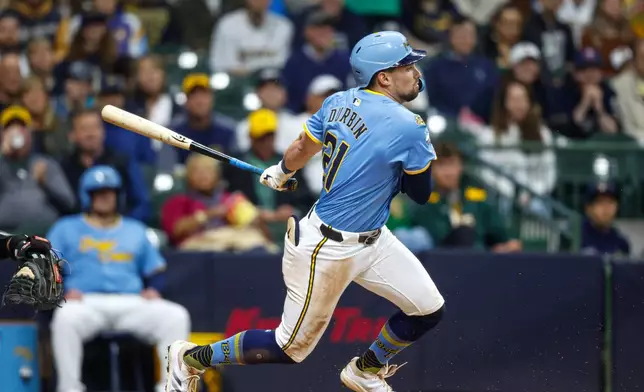 Milwaukee Brewers' Caleb Durbin watches his first MLB hit, in the third inning of a baseball game against the Athletics, Friday, April 18, 2025, in Milwaukee. (AP Photo/Jeffrey Phelps)