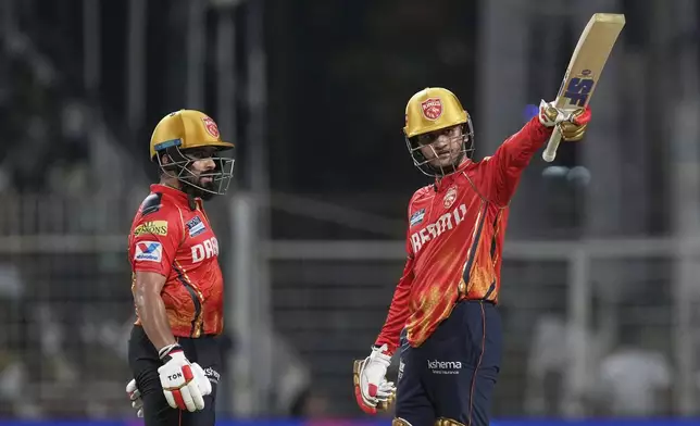 Punjab Kings' Priyansh Arya, right, celebrates his fifty runs as batting partner Prabhsimran Singh watches during the Indian Premier League cricket match between Kolkata Knight Riders and Punjab Kings at Eden Gardens in Kolkata in Kolkata , India, Saturday, April 26, 2025. (AP Photo/Bikas Das)