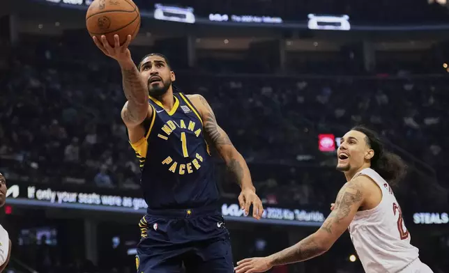 Indiana Pacers forward Obi Toppin (1) goes to the basket past Cleveland Cavaliers forward Jaylon Tyson, right, in the first, half of an NBA basketball game Sunday, April 13, 2025, in Cleveland. (AP Photo/Sue Ogrocki)