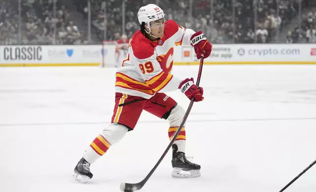 Calgary Flames defenseman Zayne Parekh shoots the puck during the first period of an NHL hockey game against the Los Angeles Kings, Thursday, April 17, 2025, in Los Angeles. (AP Photo/Mark J. Terrill)
