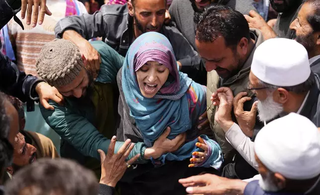A relative wails during the funeral procession of Adil Hussain Shah, a daily-wage worker, who died when militants indiscriminately opened fire on a crowd of mainly tourists on Tuesday, at his village Hapatnar, about 20 km (13 miles) from Pahalgam where the incident took place, Indian controlled Kashmir, Wednesday, April 23, 2025. (AP Photo/Dar Yasin)