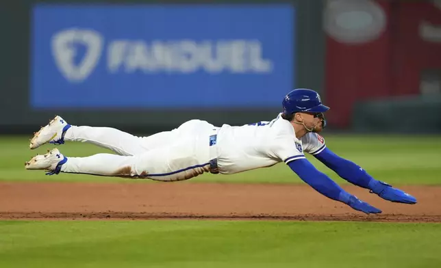 Kansas City Royals' Bobby Witt Jr. dives back to second too late to beat the tag after he was caught off base for the second out of a double play hit into by Salvador Perez during the fourth inning of a baseball game, Wednesday, April 9, 2025, in Kansas City, Mo. (AP Photo/Charlie Riedel)