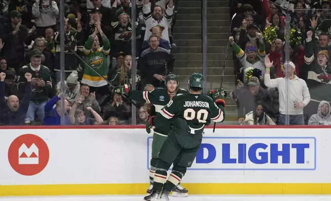 Minnesota Wild left wing Marcus Johansson (90) celebrates toward center Gustav Nyquist (41) after scoring a goal during the first period of an NHL hockey game against the San Jose Sharks, Wednesday, April 9, 2025, in St. Paul, Minn. (AP Photo/Abbie Parr)