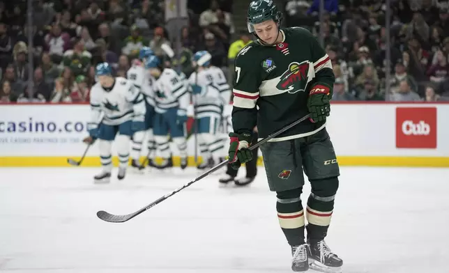 Minnesota Wild defenseman Brock Faber (7) skates after a goal scored by San Jose Sharks center Macklin Celebrini (71) during the second period of an NHL hockey game, Wednesday, April 9, 2025, in St. Paul, Minn. (AP Photo/Abbie Parr)