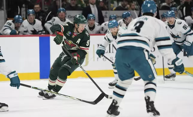 Minnesota Wild left wing Kirill Kaprizov (97) skates with the puck during the first period of an NHL hockey game against the San Jose Sharks, Wednesday, April 9, 2025, in St. Paul, Minn. (AP Photo/Abbie Parr)