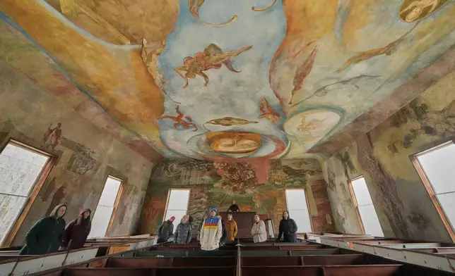 Visitors view the frescoes at the South Solon Meeting House, Sunday, April 6, 2025, in Solon, Maine. (AP Photo/Robert F. Bukaty)