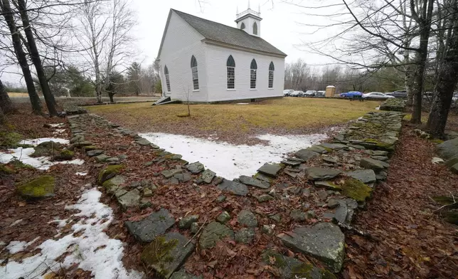 A rock wall surrounds the South Solon Meeting House, Sunday, April 6, 2025, in Solon, Maine. (AP Photo/Robert F. Bukaty)