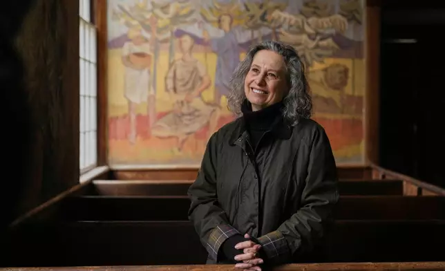 Veronique Plesch, an art professor at Colby College, pauses during a tour of the South Solon Meeting House, Sunday, April 6, 2025, in Solon, Maine. (AP Photo/Robert F. Bukaty)