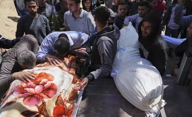 Palestinians mourn over the bodies of their relatives who were killed in an Israeli airstrike, as they brought to Shifa Hospital in Gaza City, on Saturday, April 26, 2025. (AP Photo/Jehad Alshrafi)