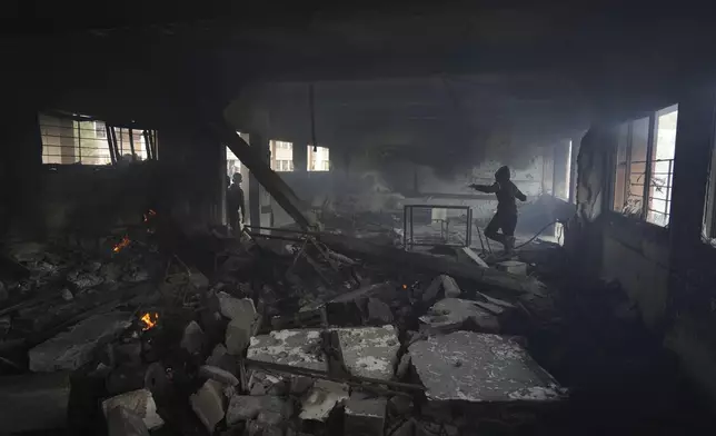 Palestinians inspect the damage after an Israeli airstrike early this morning on Yaffa School, in Gaza City, Wednesday, April 23, 2025. (AP Photo/Jehad Alshrafi)