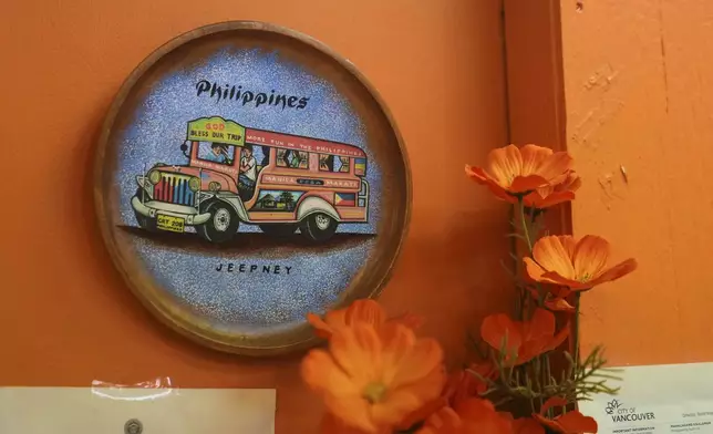 Art hangs on a wall at Plato Filipino restaurant in Vancouver, British Columbia, Monday, April 28, 2025. (AP Photo/Lindsey Wasson)