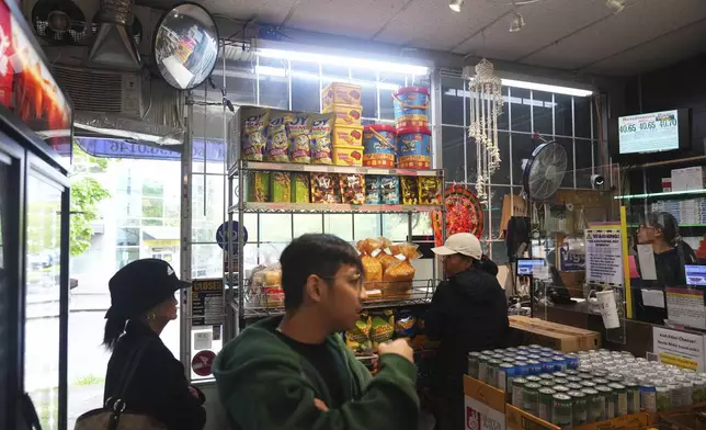 People shop at Sari-Sari Filipino Convenience Store in Vancouver, British Columbia, Monday, April 28, 2025. (AP Photo/Lindsey Wasson)