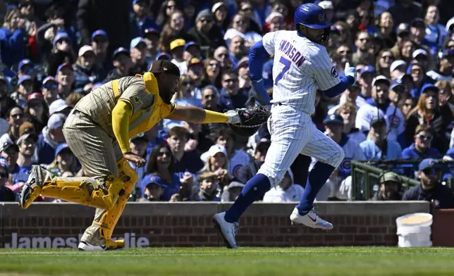 San Diego Padres catcher Elias Díaz (17) tags Chicago Cubs' Dansby Swanson (7) out during the first inning of a baseball game, Sunday, April 6, 2025, in Chicago. (AP Photo/Matt Marton)