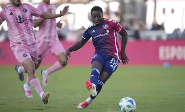 FC Dallas midfielder Anderson Julio (11) shoots and scores a goal as Inter Miami defender Gonzalo Luján, left, looks on during the second half of an MLS soccer match, Sunday, April 27, 2025, in Fort Lauderdale, Fla. (AP Photo/Jim Rassol)