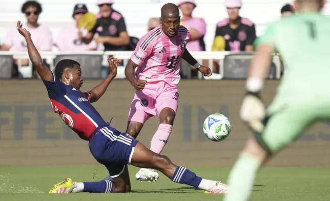 FC Dallas midfielder Kaick Ferreira, left, clears the ball away from Inter Miami midfielder Fafà Picault (7) during the first half of an MLS soccer match, Sunday, April 27, 2025, in Fort Lauderdale, Fla. (AP Photo/Jim Rassol)