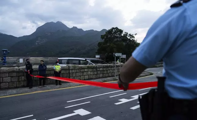 Police officers stand guard outside the Shek Pik Prison as former pro-democracy lawmaker Gary Fan, was released after four years for his conviction under the national security law in Hong Kong, Tuesday, April 29, 2025. (AP Photo/Chan Long Hei)