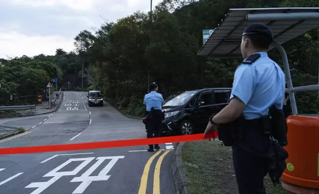 Police officers stand guard outside the Shek Pik Prison as former pro-democracy lawmaker Gary Fan, was released after four years for his conviction under the national security law in Hong Kong, Tuesday, April 29, 2025. (AP Photo/Chan Long Hei)