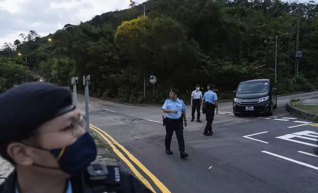 Police officers stand guard outside the Shek Pik Prison as former pro-democracy lawmaker Gary Fan was released after four years for his conviction under the national security law in Hong Kong, Tuesday, April 29, 2025. (AP Photo/Chan Long Hei)