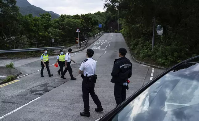 Police officers stand guard outside the Shek Pik Prison as former pro-democracy lawmaker Gary Fan, was released after four years for his conviction under the national security law in Hong Kong, Tuesday, April 29, 2025. (AP Photo/Chan Long Hei)