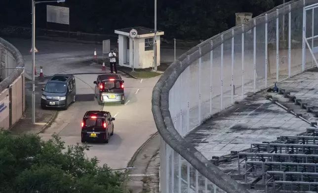 Vehicles believed to be carrying former pro-democracy lawmaker Gary Fan, who was released after four years for his conviction under the national security law, leaves the Shek Pik Prison in Hong Kong, Tuesday, April 29, 2025. (AP Photo/Chan Long Hei)