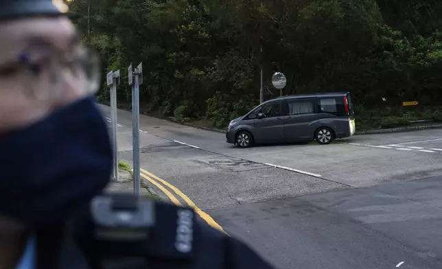 Vehicles believed to be carrying former pro-democracy lawmaker Gary Fan, who was released after four years for his conviction under the national security law, leaves the Shek Pik Prison in Hong Kong, Tuesday, April 29, 2025. (AP Photo/Chan Long Hei)