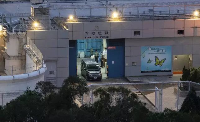 Vehicles believed to be carrying former pro-democracy lawmaker Gary Fan, who was released after four years for his conviction under the national security law, leaves the Shek Pik Prison in Hong Kong, Tuesday, April 29, 2025. (AP Photo/Chan Long Hei)