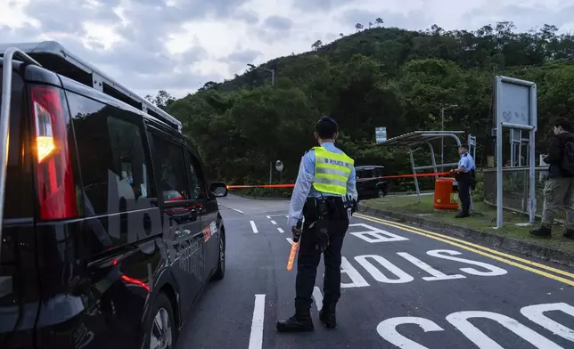 Police officers stand guard outside the Shek Pik Prison as former pro-democracy lawmaker Gary Fan, was released after four years for his conviction under the national security law in Hong Kong, Tuesday, April 29, 2025. (AP Photo/Chan Long Hei)
