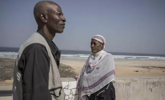 Pathe Gueye, left, and Ndeye Lam, right, stand on their roof in Dakar, Senegal Saturday, Jan. 11, 2025. Their daughter Mariama died at age 13 of a rare genetic disease. (AP Photo/Annika Hammerschlag)