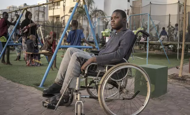 Mamadou, 13, watches children play in Dakar, Senegal, Saturday January 11, 2025. (AP Photo/Annika Hammerschlag)