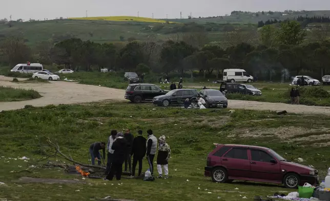People gather outdoors away from urban areas following an earthquake shock with a preliminary magnitude of 6.2, in Istanbul, Turkey, Wednesday, April 23, 2025. (AP Photo/Khalil Hamra)