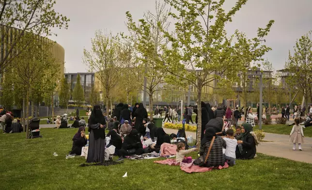 People gather outdoors following an earthquake shock with a preliminary magnitude of 6.2, in Istanbul, Turkey, Wednesday, April 23, 2025. (AP Photo/Khalil Hamra)