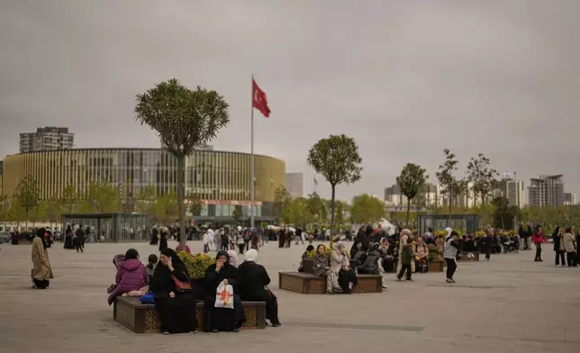 People gather outdoors following an earthquake shock with a preliminary magnitude of 6.2, in Istanbul, Turkey, Wednesday, April 23, 2025. (AP Photo/Khalil Hamra)