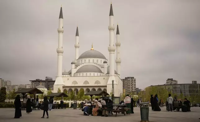 People gather outdoors following an earthquake shock with a preliminary magnitude of 6.2, in Istanbul, Turkey, Wednesday, April 23, 2025. (AP Photo/Khalil Hamra)