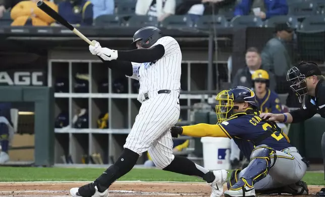 Chicago White Sox's Andrew Vaughn hits a single during the first inning of a baseball game against the Milwaukee Brewers in Chicago, Tuesday, April 29, 2025. (AP Photo/Nam Y. Huh)