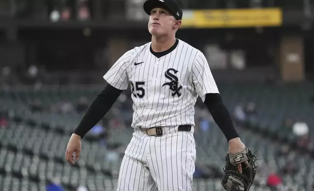 Chicago White Sox first baseman Andrew Vaughn stretches as he looks to fans before a baseball game against the Milwaukee Brewers in Chicago, Tuesday, April 29, 2025. (AP Photo/Nam Y. Huh)