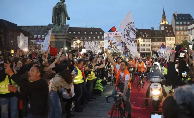 Protesting Serbian university students who rode bicycles from Novi Sad, Serbia, arrive the heart of the European Union to seek support, Tuesday, April 15, 2025 in Strasbourg, eastern France. (AP Photo/Antonin Utz)