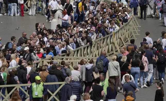 People line up to enter St. Peter's Basilica and pay their respect to the late Pope Francis, at the Vatican, Thursday April 24, 2025. (AP Photo/Gregorio Borgia)