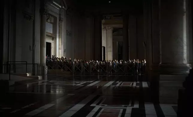People line up as they enter St. Peter's Basilica to pay their respects to Pope Francis lying in state, at the Vatican, Thursday, April 24, 2025. (AP Photo/Emilio Morenatti)