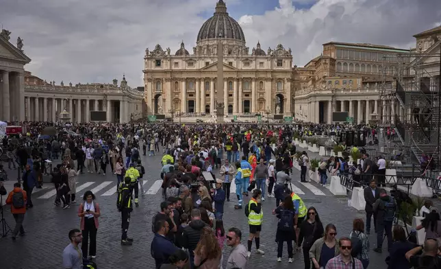 People line up to enter St. Peter's Basilica to pay their respects to Pope Francis lying in state, at the Vatican, Thursday, April 24, 2025. (AP Photo/Emilio Morenatti)