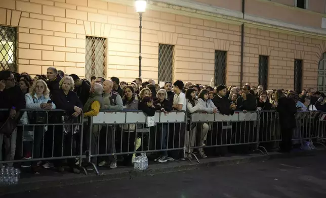 People line up next to St. Peter's Square at the Vatican, Wednesday, April 23, 2025 as the body of the late Pope Francis will lie in state inside St. Peter's Basilica for three days. (AP Photo/Markus Schreiber)