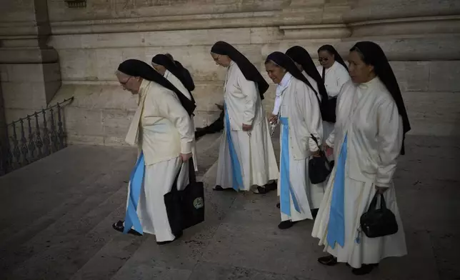 Nuns leave after entering the St. Peter's Basilica to pay their respects to Pope Francis lying in state, at the Vatican, Thursday, April 24, 2025. (AP Photo/Emilio Morenatti)